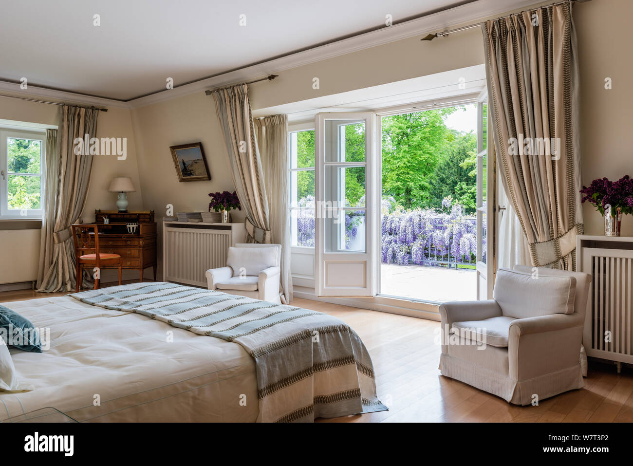 Open double doors in country style bedroom Stock Photo - Alamy