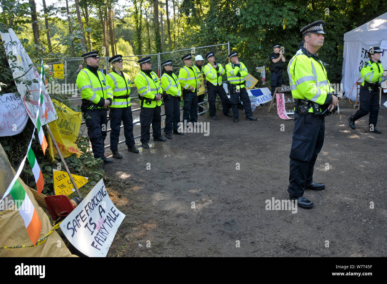 Anti-fracking protest, policemen guarding entrance to test drilling sight, Balcombe, West Sussex, England. 19th August 2013. Stock Photo