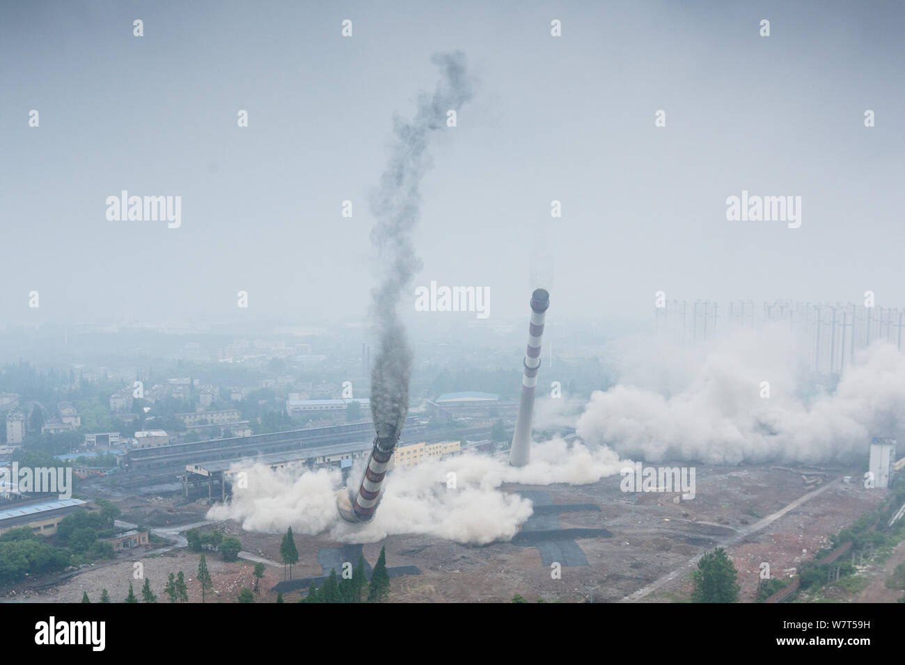 Two 180-meter-tall chimneys and a cooling tower are demolished by ...