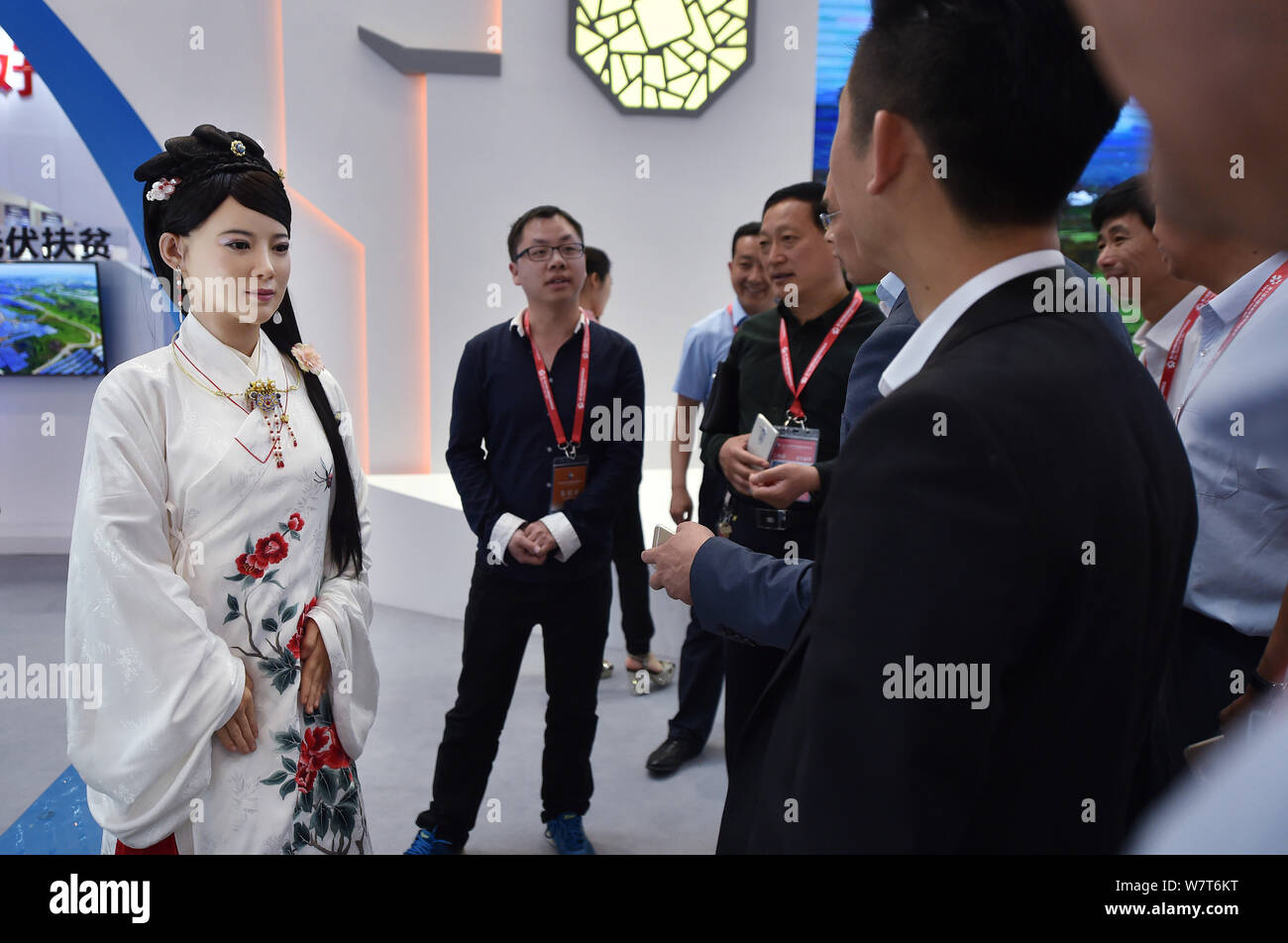 China's first advanced interactive robot Jia Jia, left, interacts with visitors at the 10th Central China Investment and Trade Expo (Central China Exp Stock Photo