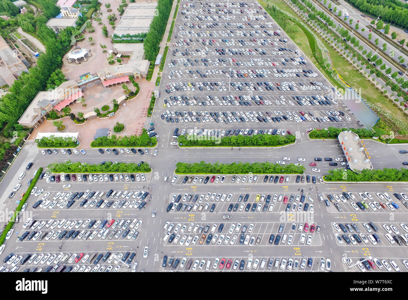 Aerial view of vehicles in the fully packed parking lot of an amusement