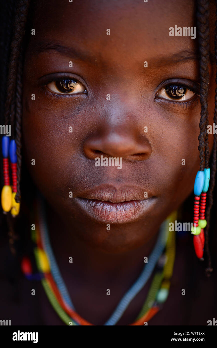 Portrait of Ovahakaona girl with photographer reflected in her eyes, Kaokoland, Namibia. Stock Photo