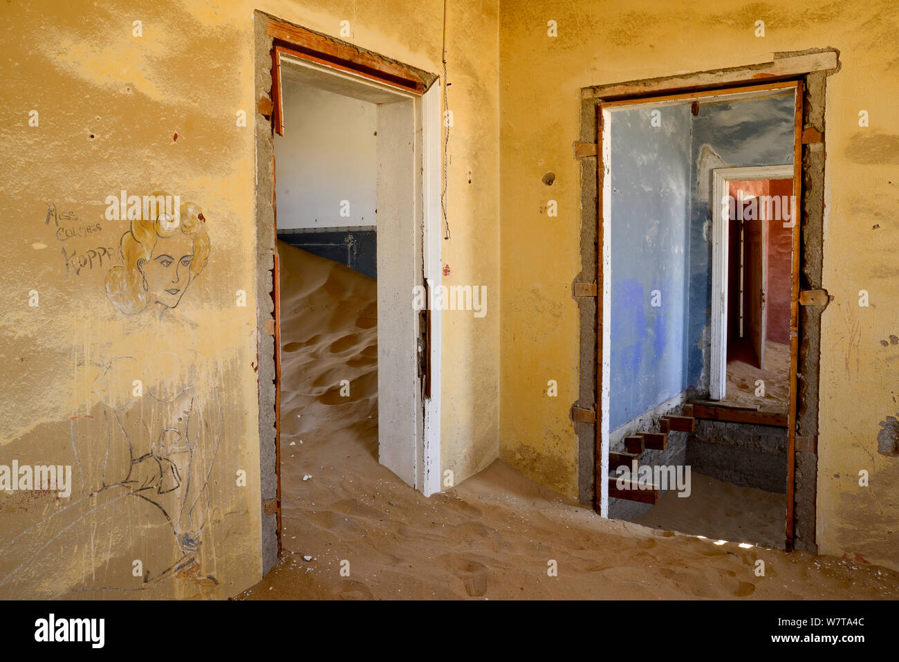 Abandoned house full of sand, Kolmanskop Ghost Town, an old diamond-mining town where shifting sand dunes have encroached abandoned houses, Namib Desert Namibia, October 2013. Stock Photo