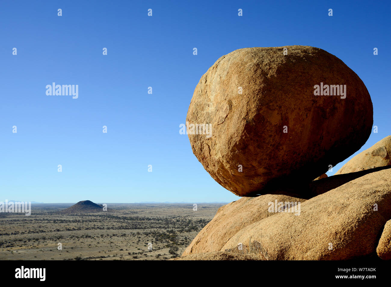 Boulder and landscape seen from the Spitzkoppe mountain range, Namibia. Stock Photo