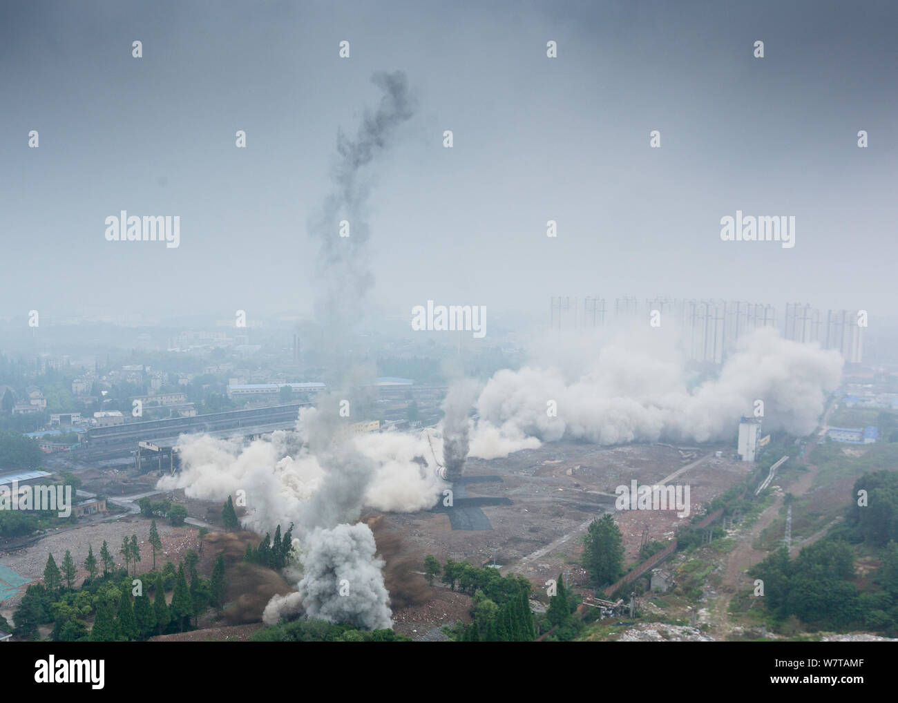 Two 180-meter-tall chimneys and a cooling tower are demolished by explosion at Nanjing No.2 Thermal Power Plant in Nanjing city, east China's Jiangsu Stock Photo