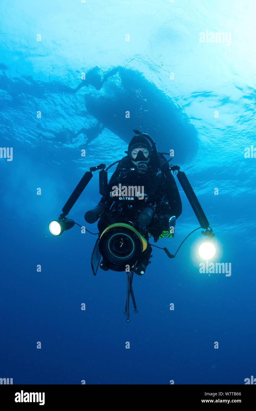 Female scuba diver and filmmaker with large underwater camera system