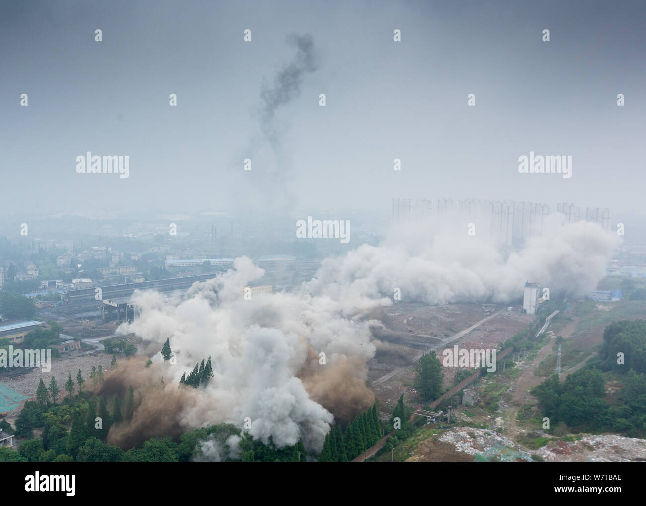 Dense smoke spreads after two 180-meter-tall chimneys and a cooling ...
