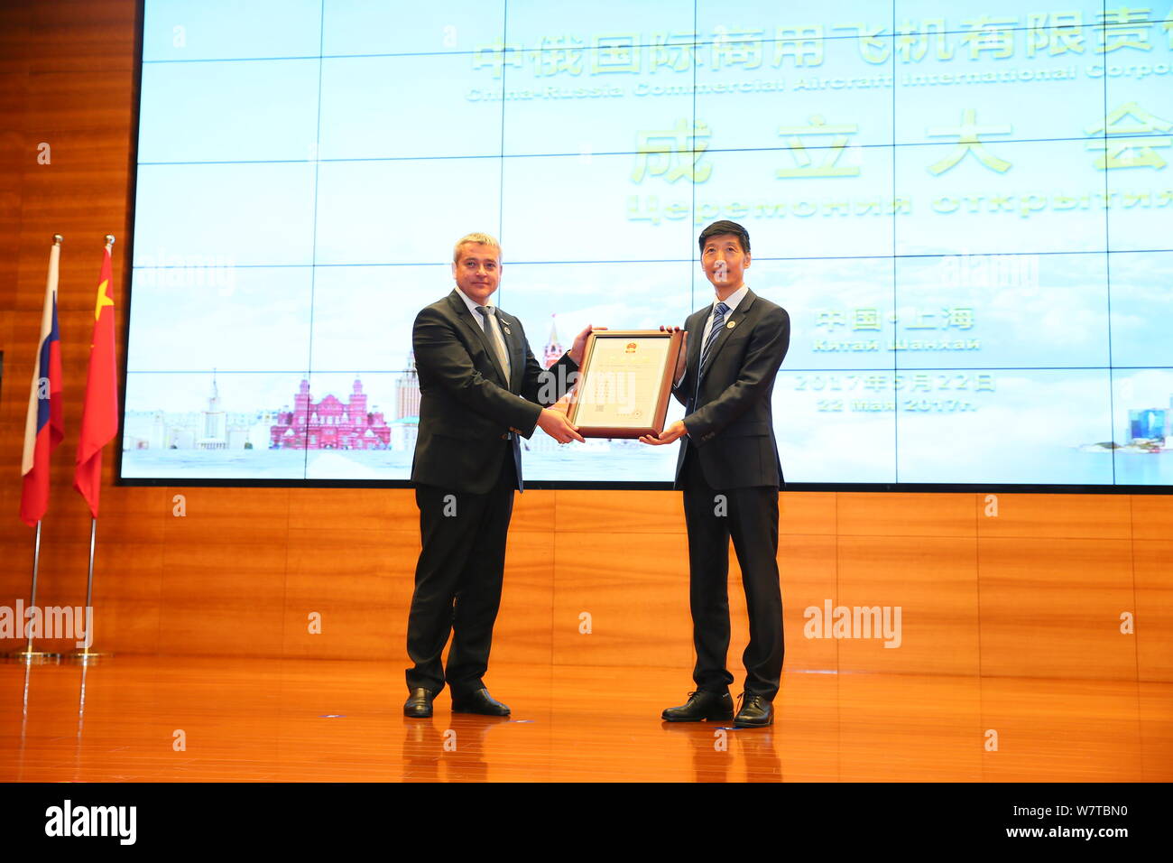 Guests show the business license of the Shanghai-based China-Russia Commercial Aircraft International Co., Ltd (CRAIC) during the inauguration ceremon Stock Photo