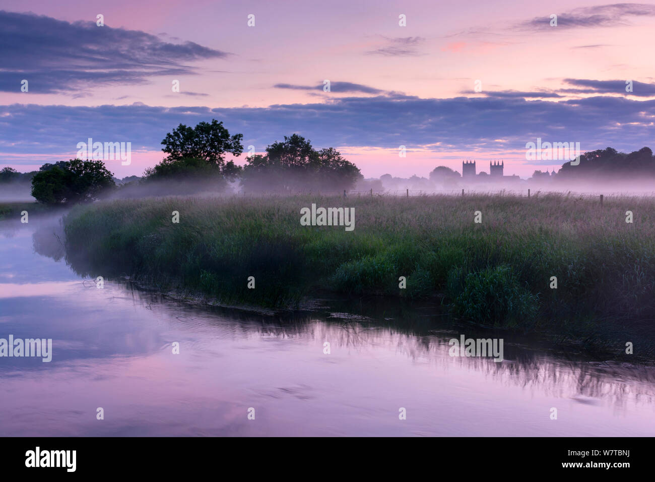 River Stour with early morning mist at sunrise, view toward Wimborne Minster, Dorset, UK, June 2013. Stock Photo