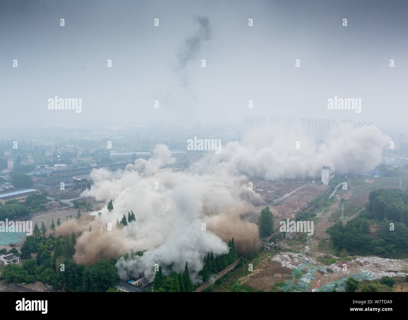 Dense smoke spreads after two 180-meter-tall chimneys and a cooling ...