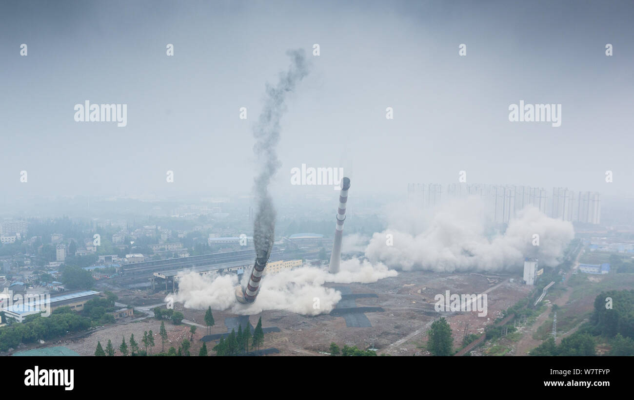 Two 180-meter-tall chimneys and a cooling tower are demolished by ...