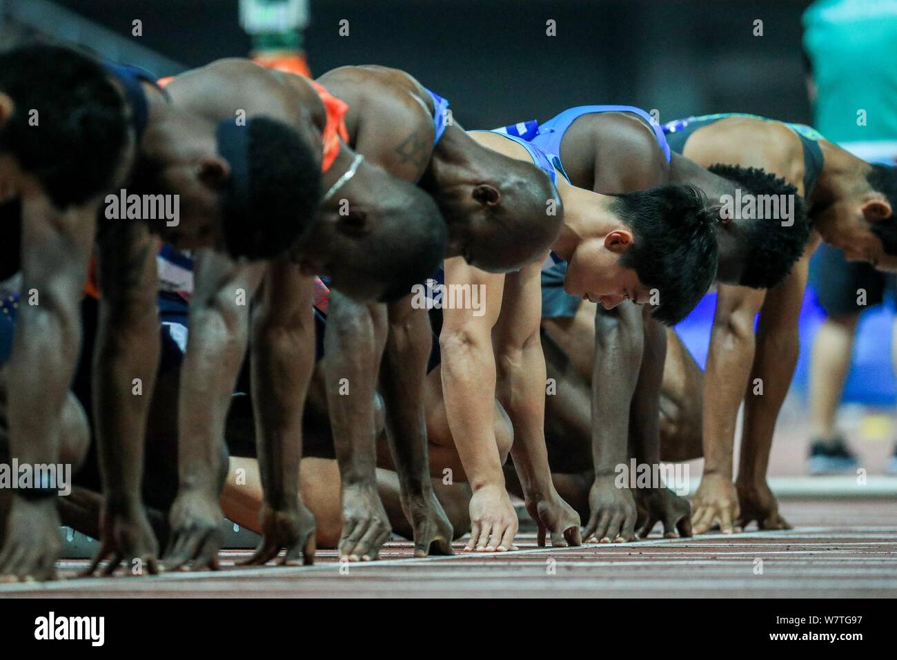 Athletes get ready for the men's 100m final during the IAAF Diamond