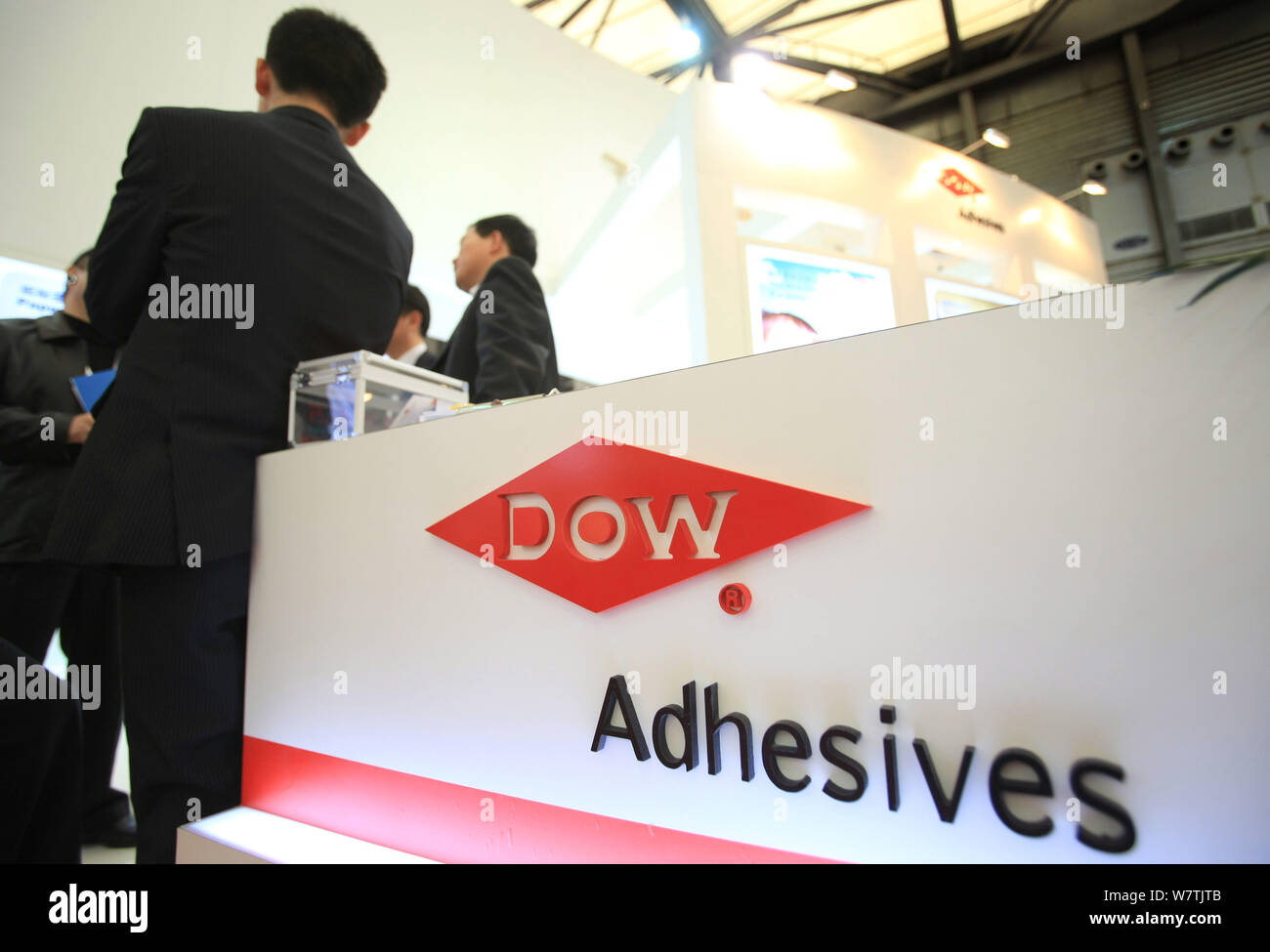 --FILE--Chinese employees are seen at the stand of Dow Chemical during an exhibition in Shanghai, China, 3 December 2009.   China has decided to green Stock Photo