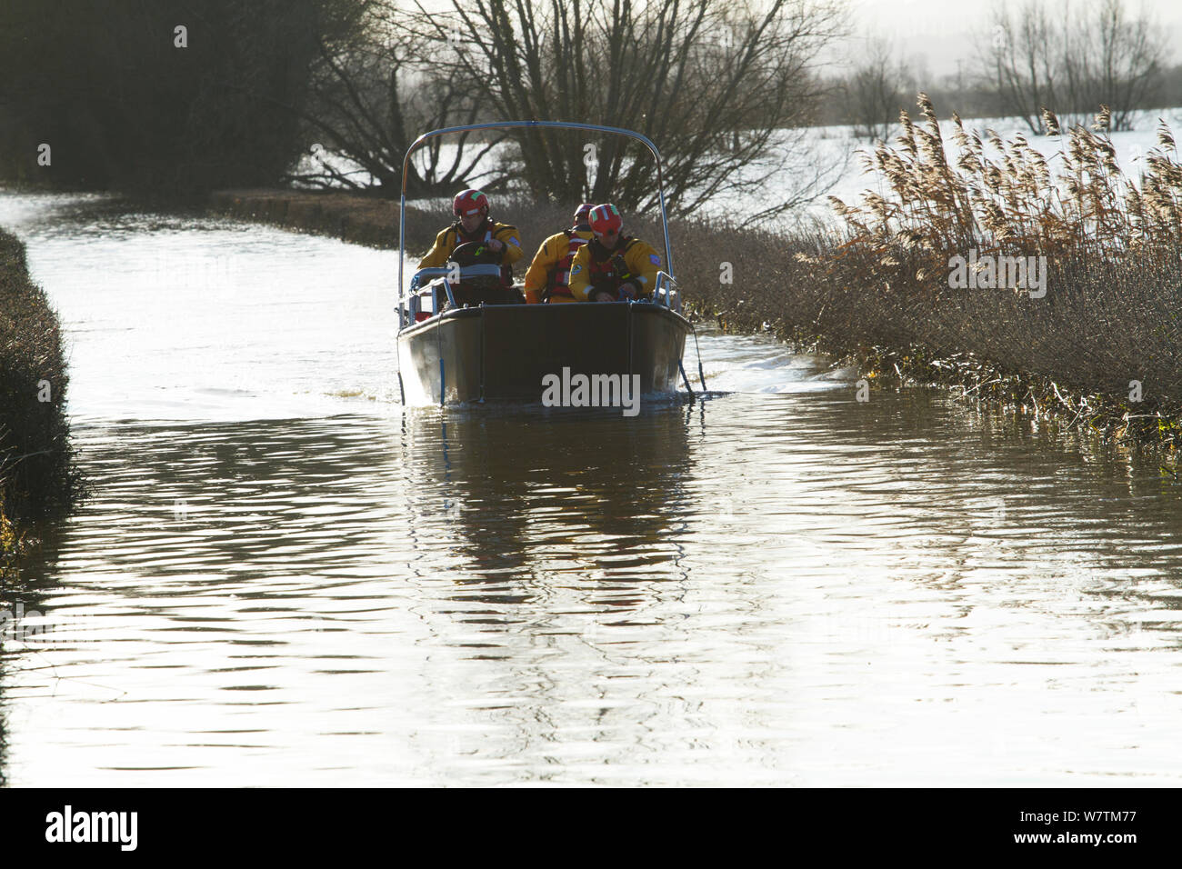 Rescue boat carrying flood victims to Muchelney during January 2014 floods, Somerset Levels, England, UK, 11th January 2014. Stock Photo
