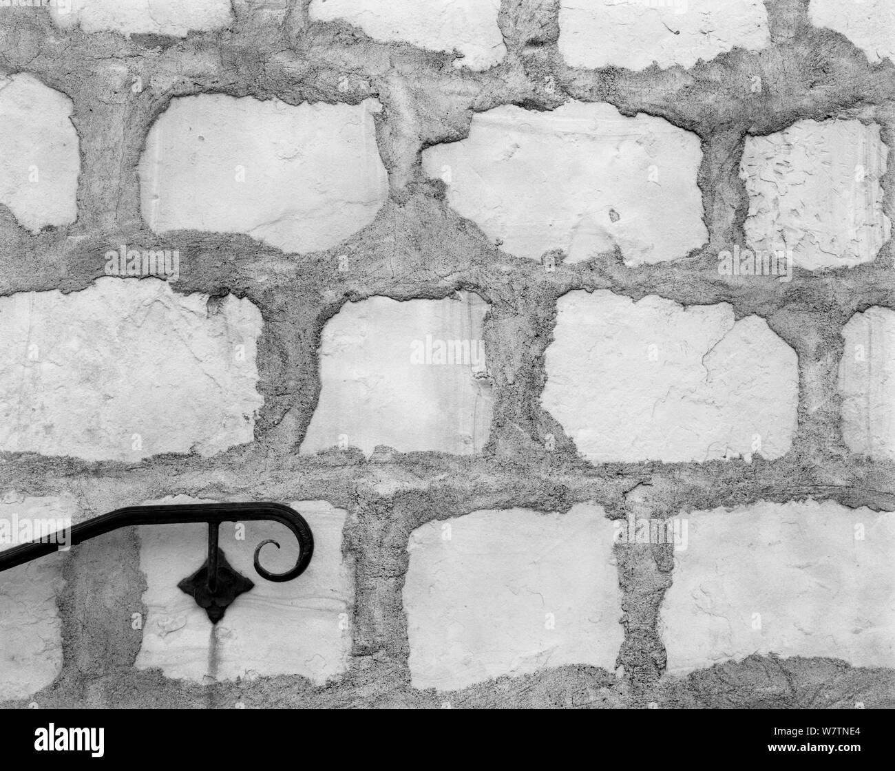 Black and white photograph of stone wall and hand rail at Mission, Santa Barbara, California, USA. Stock Photo