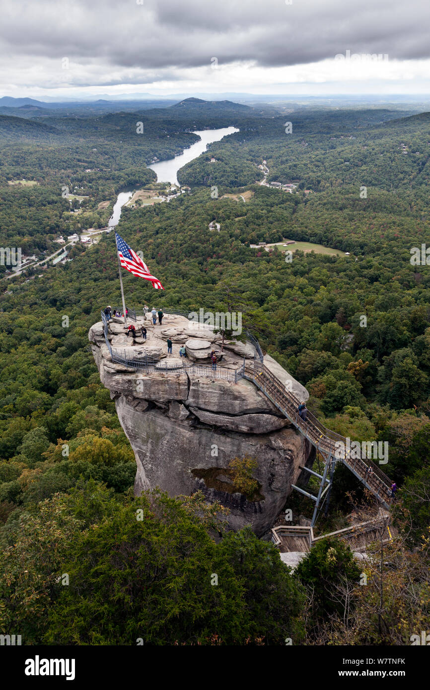 American stars and stripes flag on top of Chimney Rock in Chimney Rock State Park. North Carolina, USA, October 2013. Stock Photo