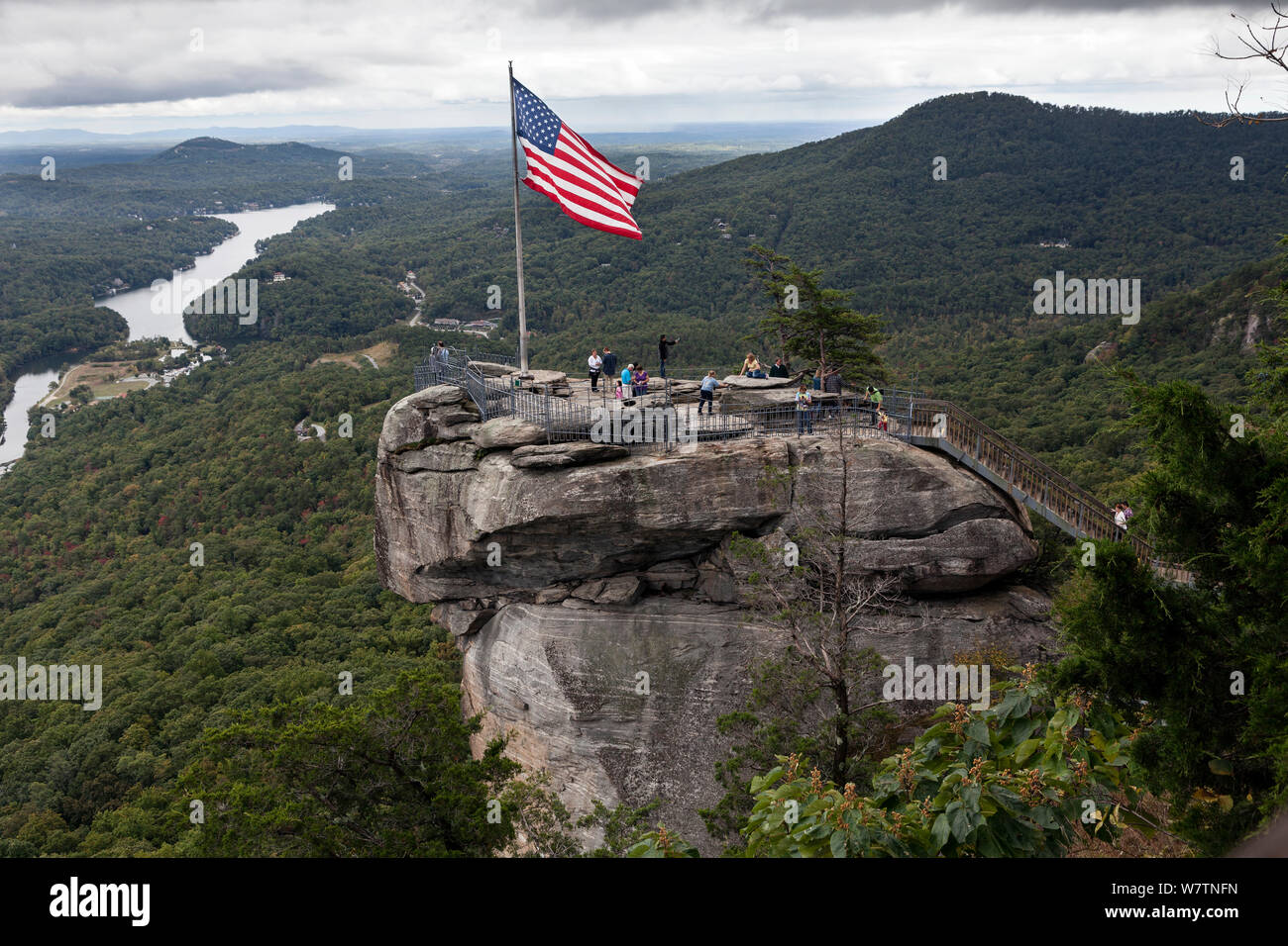 American Stars and stripes flag on top of Chimney Rock in Chimney Rock State Park. North Carolina, USA, October 2013. Stock Photo