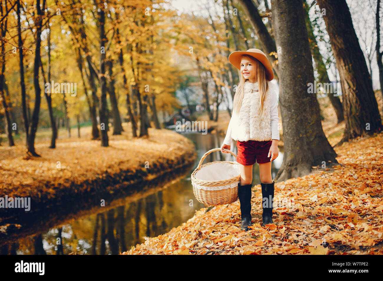 Cute little girl in a autumn park Stock Photo - Alamy