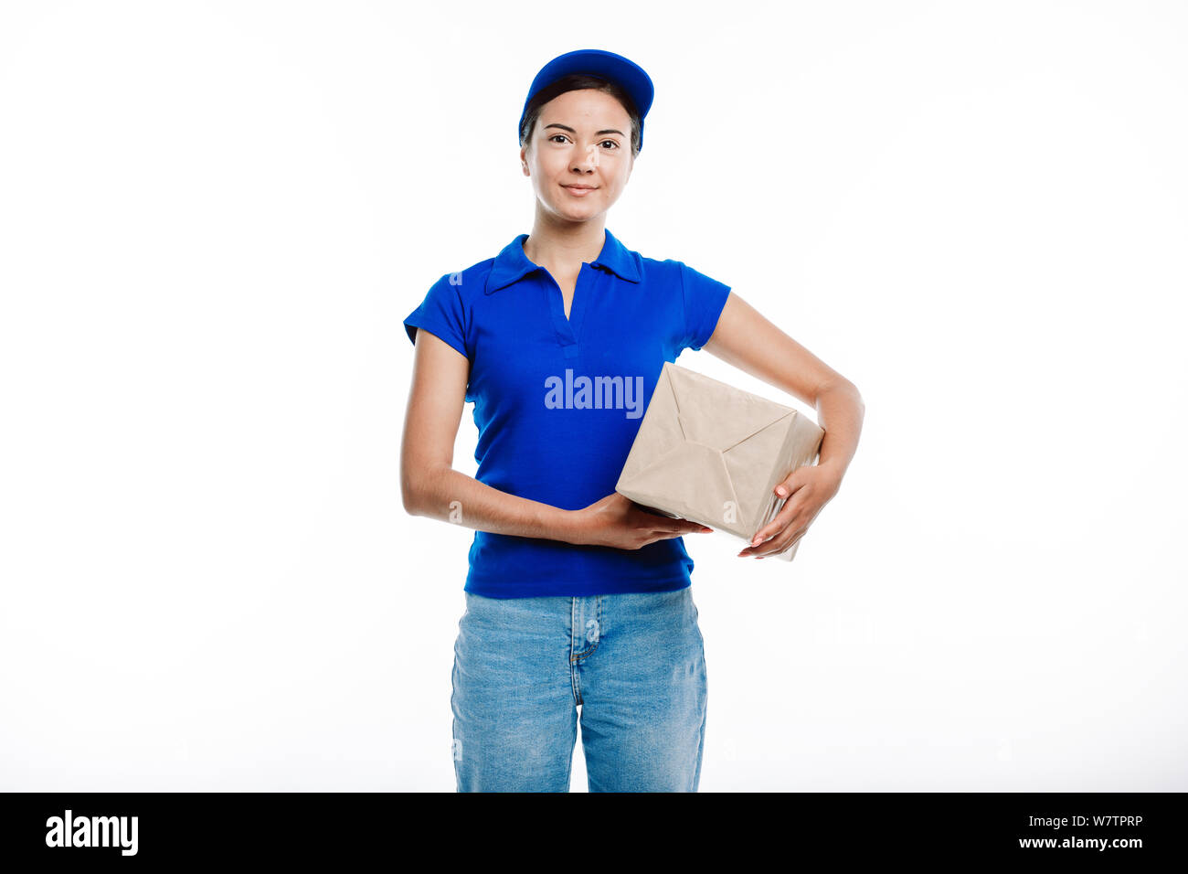 Girl working in deivery service poses at the camera. Stock Photo