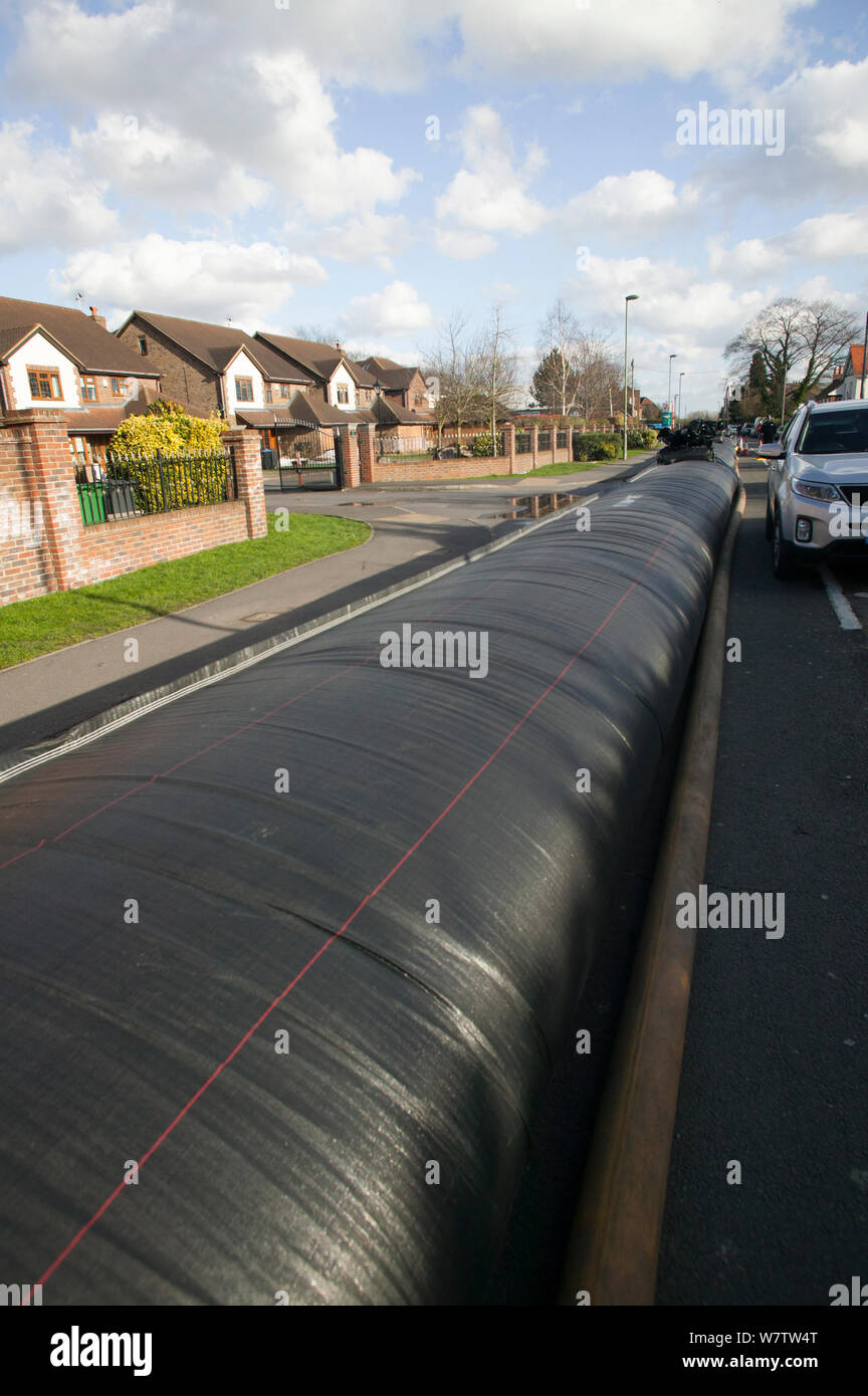 Flood protection barrier (filled with water) to protect homes during February 2014 flooding. Chertsey, Surrey, England, UK, 16th February 2014. Stock Photo