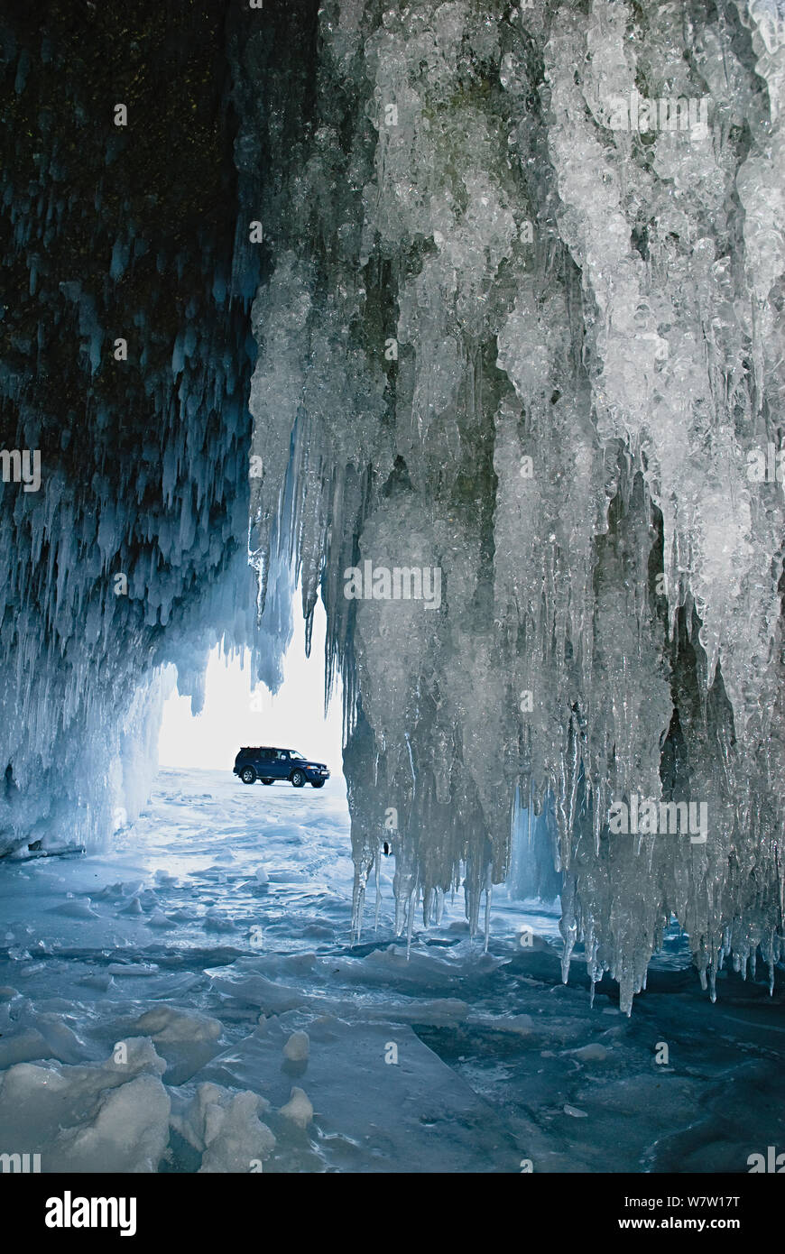 Ice formations in cave - with car outside, Lake Baikal, Siberia, Russia, March. Stock Photo