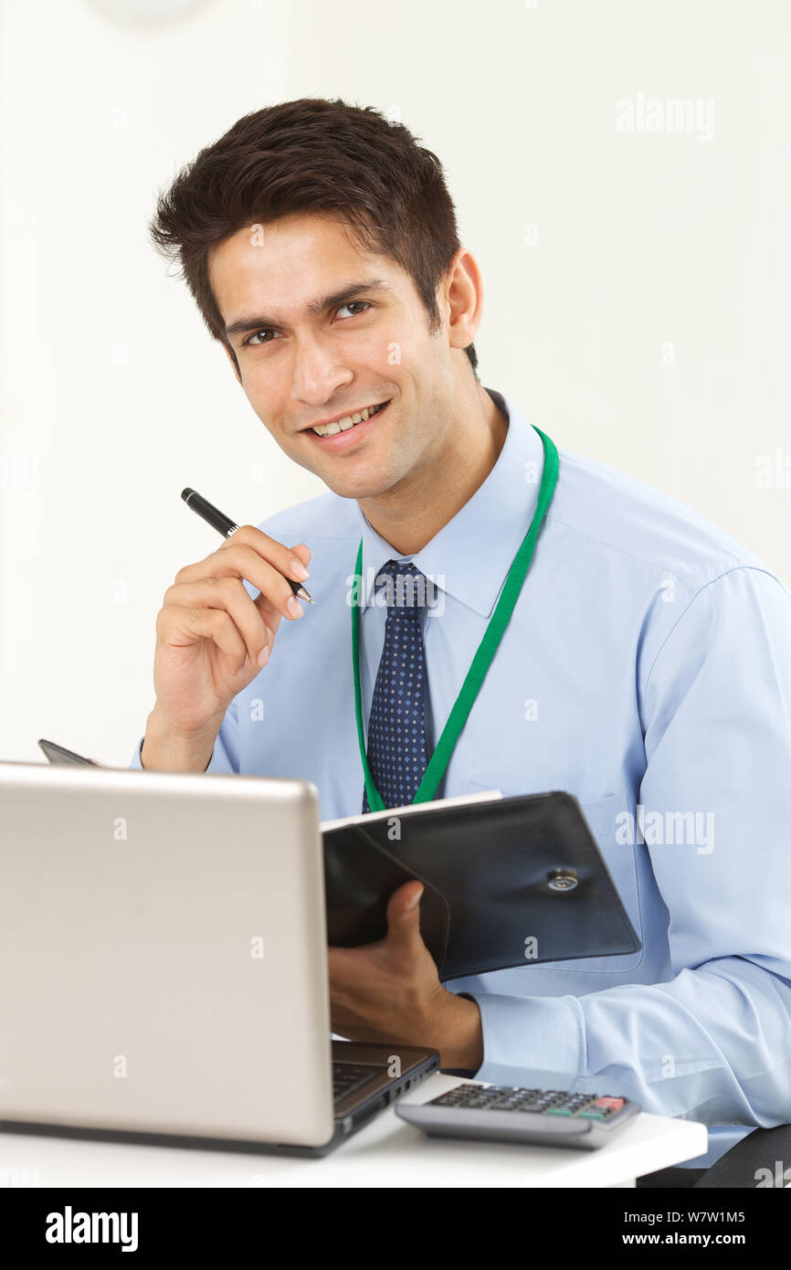Businessman writing in a personal organizer Stock Photo