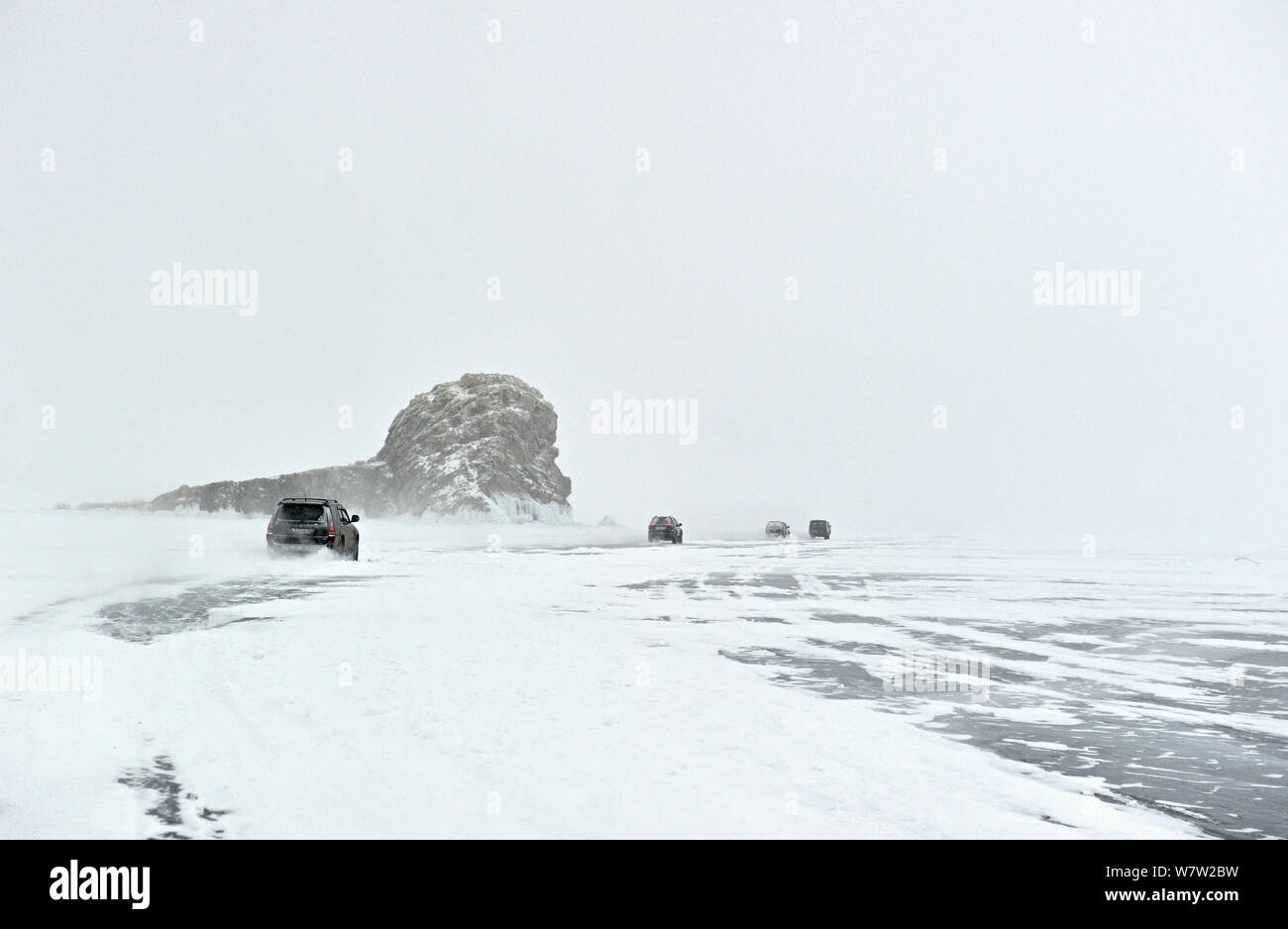 Cars driving across Lake Baikal ice in spring, Siberia, Russia, March. Stock Photo