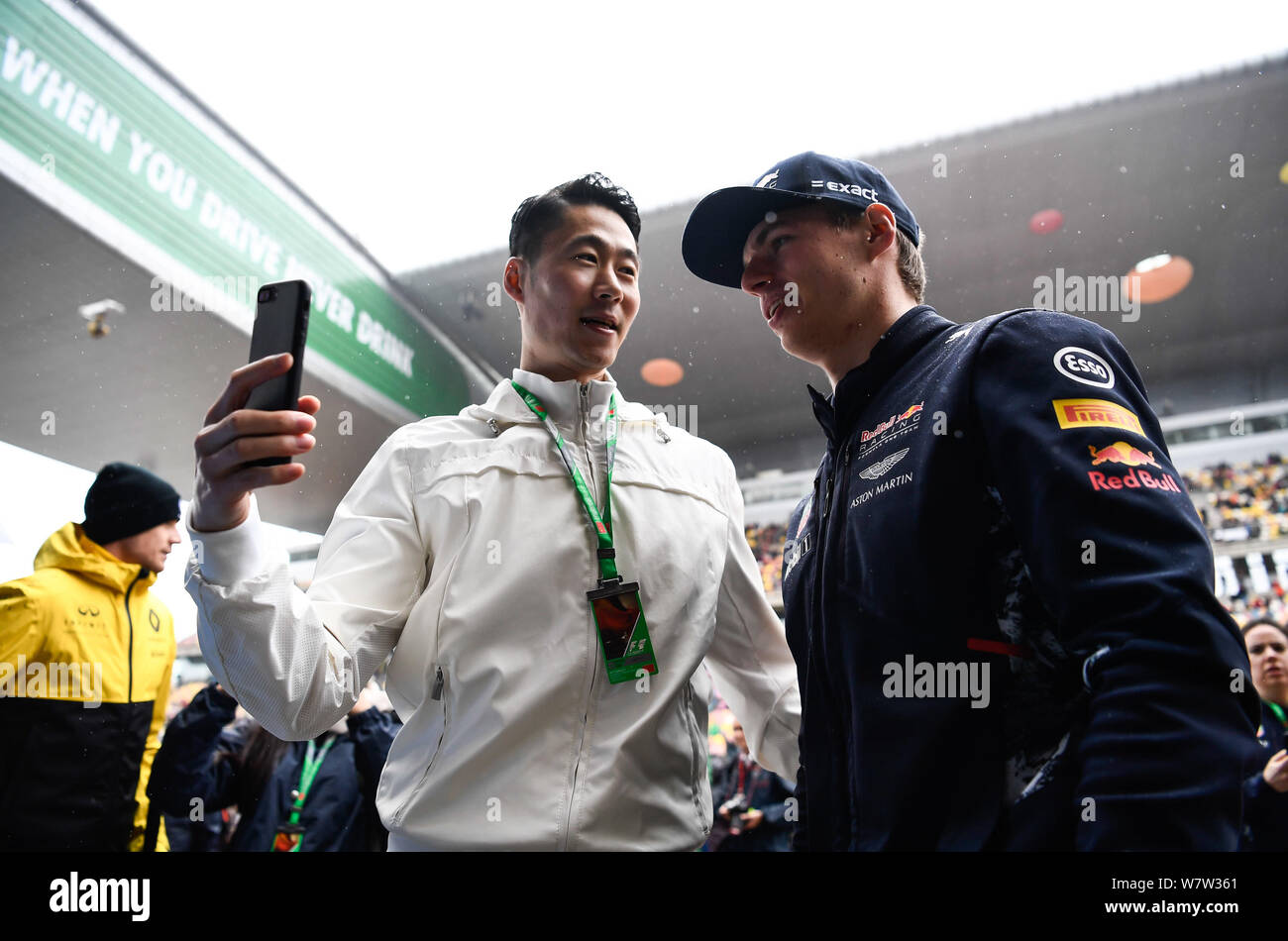 Dutch F1 driver Max Verstappen of Red Bull Racing, right, takes selfies with retired Chinese table tennis player Wang Liqin ahead of the 2017 Formula Stock Photo