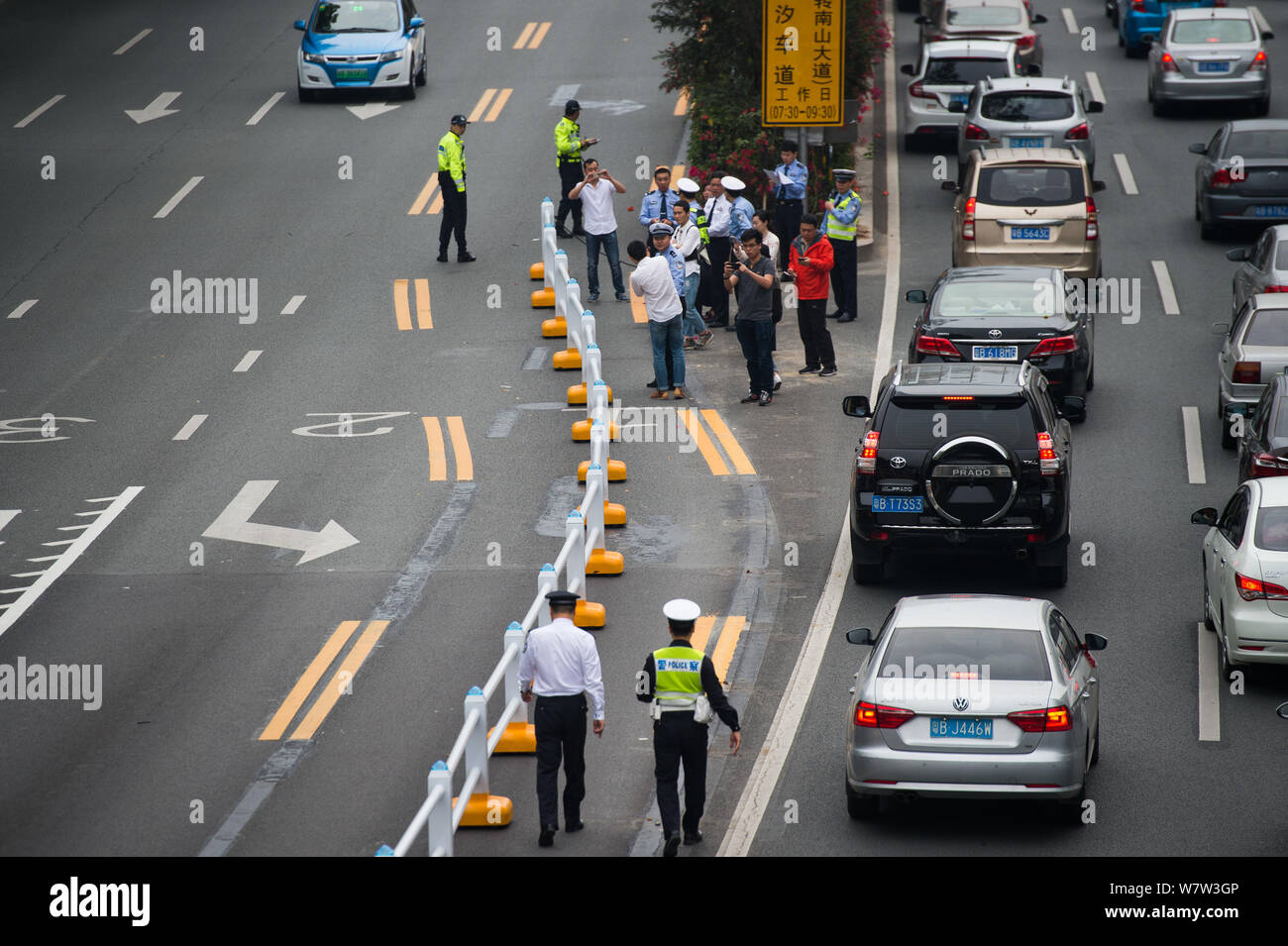 Traffic police officers remotecontrol the guardrail of a reversible