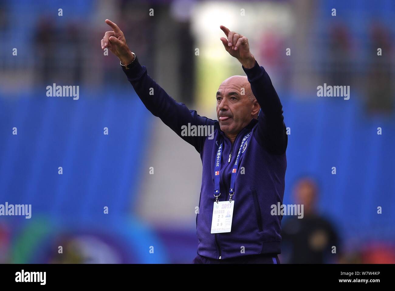 Head coach Jaime Pacheco of Tianjin TEDA watches his players competing against Yanbian Funde in their sixth round match during the 2017 Chinese Footba Stock Photo