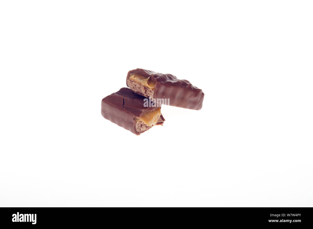 Milky Way candy bar broken in half showing filling without wrapper Stock Photo