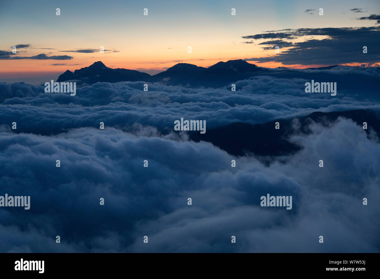 Clouds filled valley at sunset, and view from Abago to Fisht massif, Abago, Kavkazsky Zapovednik, Russia, July 2012. Stock Photo