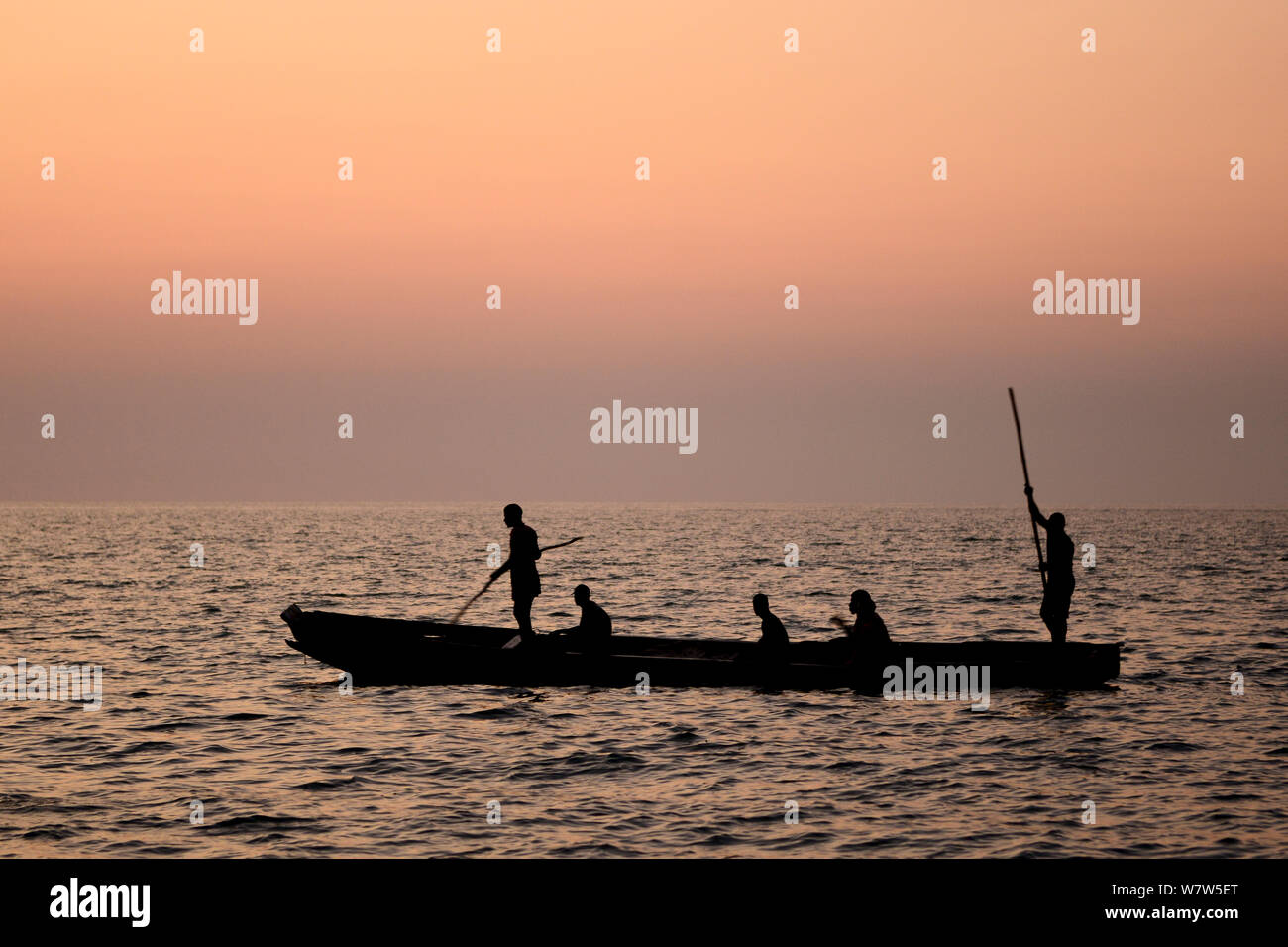 Fishermen in boat at sunset, Orango Island, Guinea-Bissau. December 2013. Stock Photo