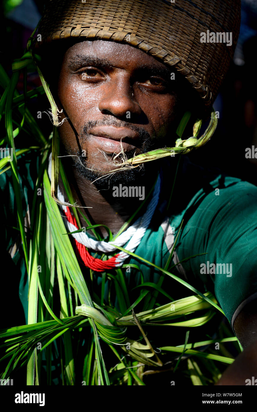 Man wearing traditional clothing made of palm leaves at wedding in Ambeduco village, Orango Island, Guinea-Bissau, December 2013. Stock Photo