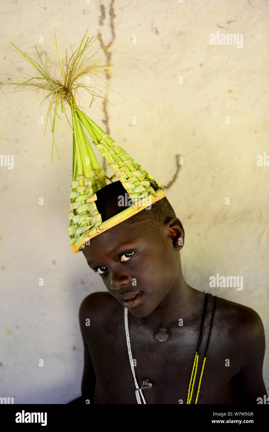 Man in ceremonial head dress of palm leaves at traditional wedding in the village of Ambeduco, Orango Island, Guinea Bissau, December 2013. Stock Photo