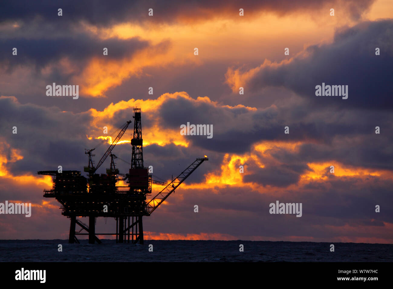 Sun setting at the Eider Platform, 60 miles northeast of Shetland, North Sea, November 2013. All non-editorial uses must be cleared individually. Stock Photo