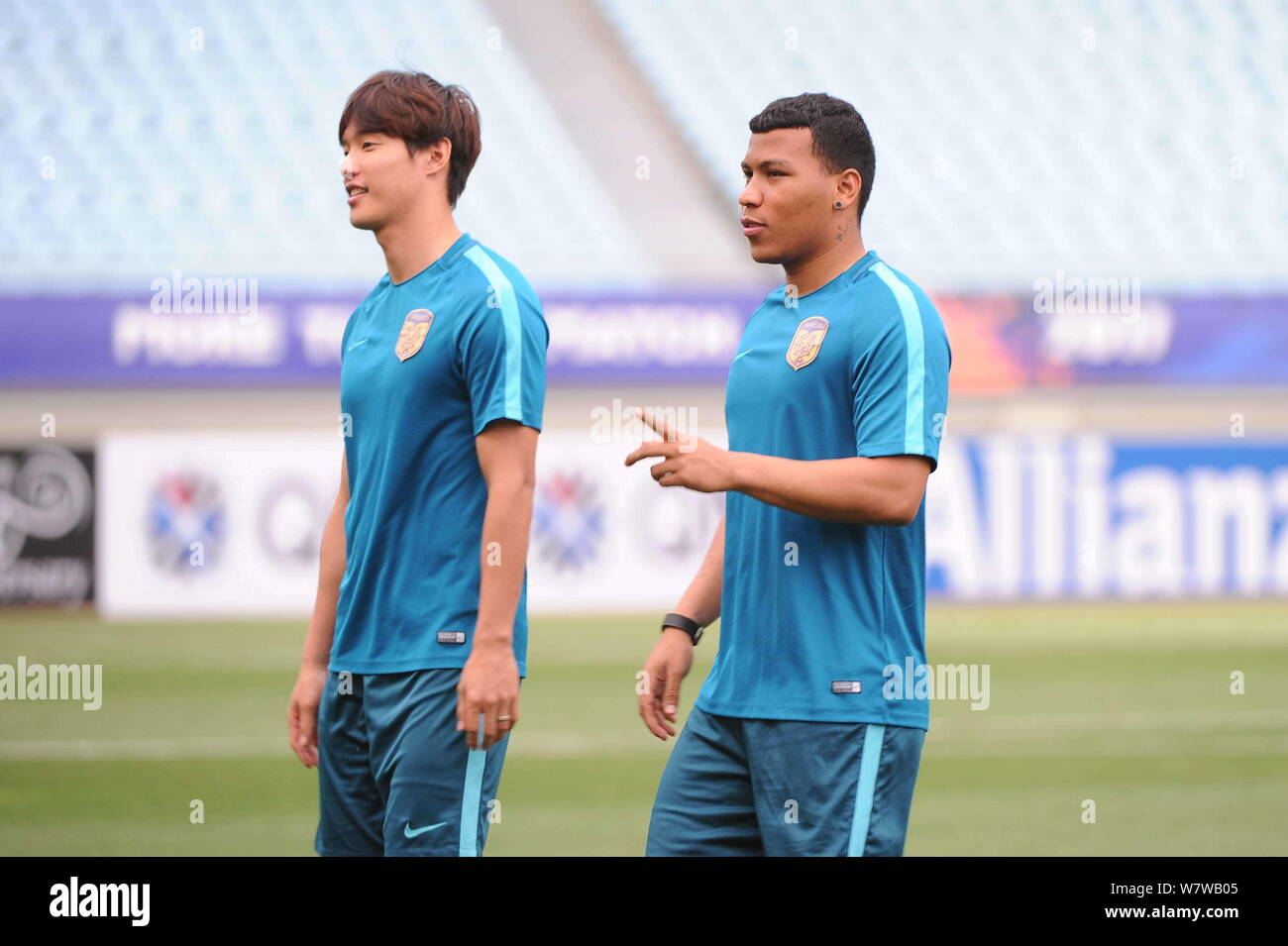 South Korean soccer player Hong Jeong-ho, left, and Colombian soccer player Roger Martinez, of China's Jiangsu Suning take part in a training session Stock Photo