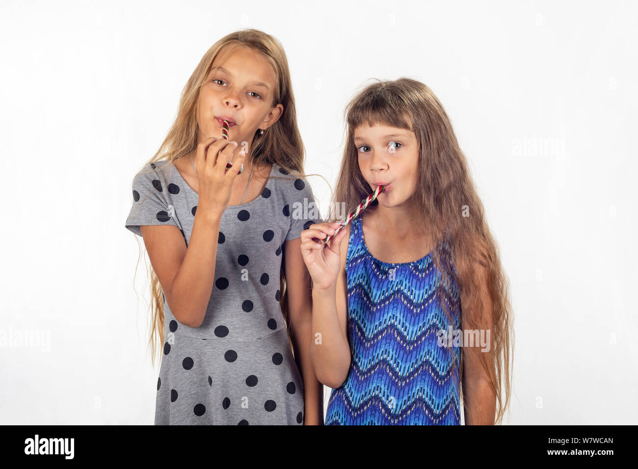 tween suck Two girls suck lollipops and look in the frame Stock Photo - Alamy