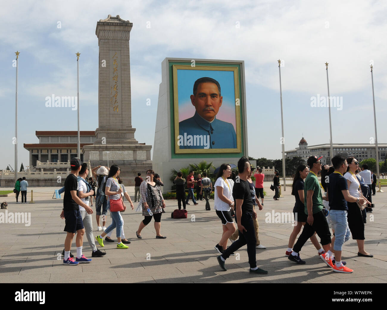 Visitors walk past the huge portrait of Sun Yat-sen, first president