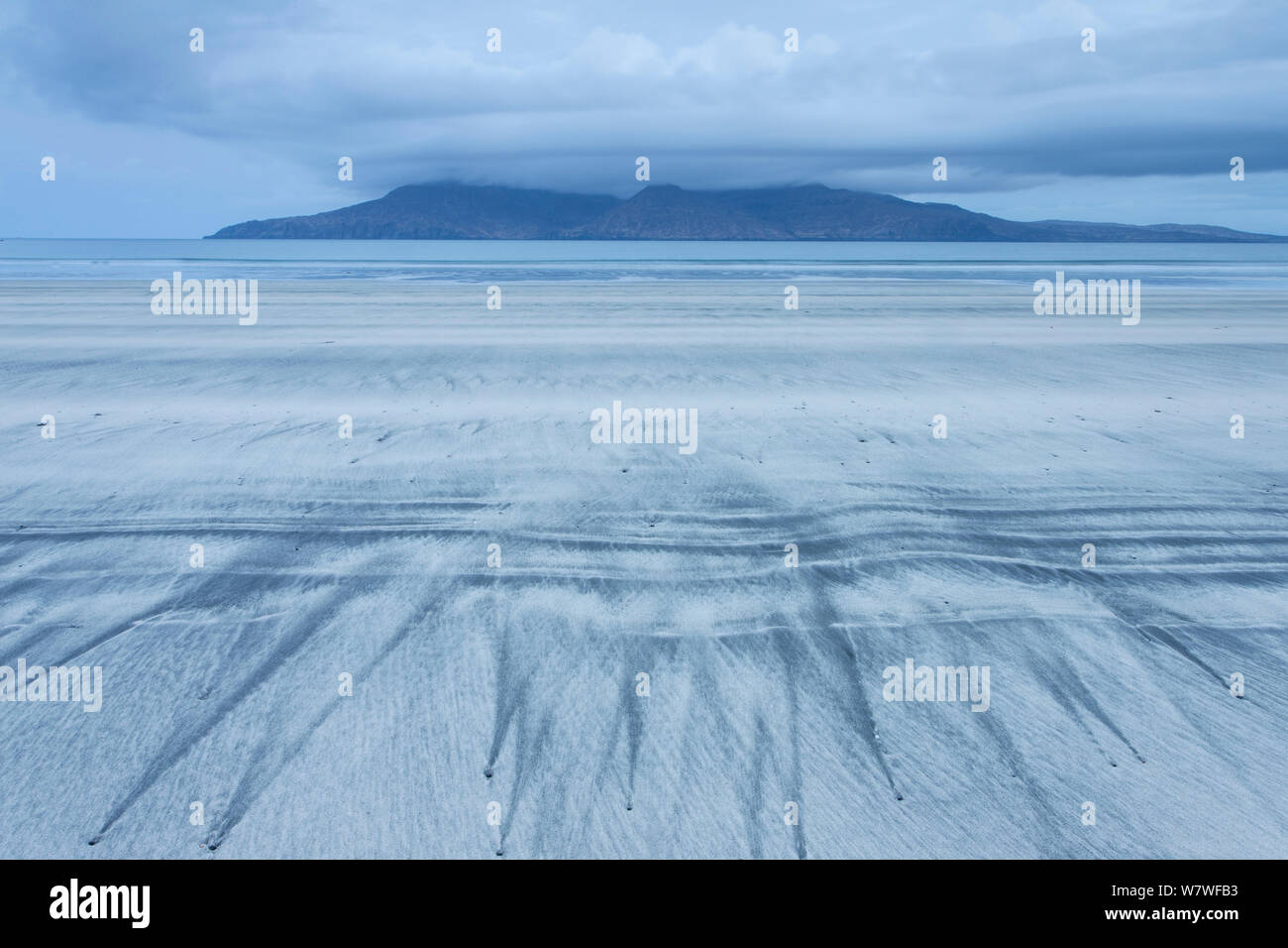 Patterns on beach and view to sea and the Isle of Rum, seen from Eigg, Scotland, May 2013. Stock Photo