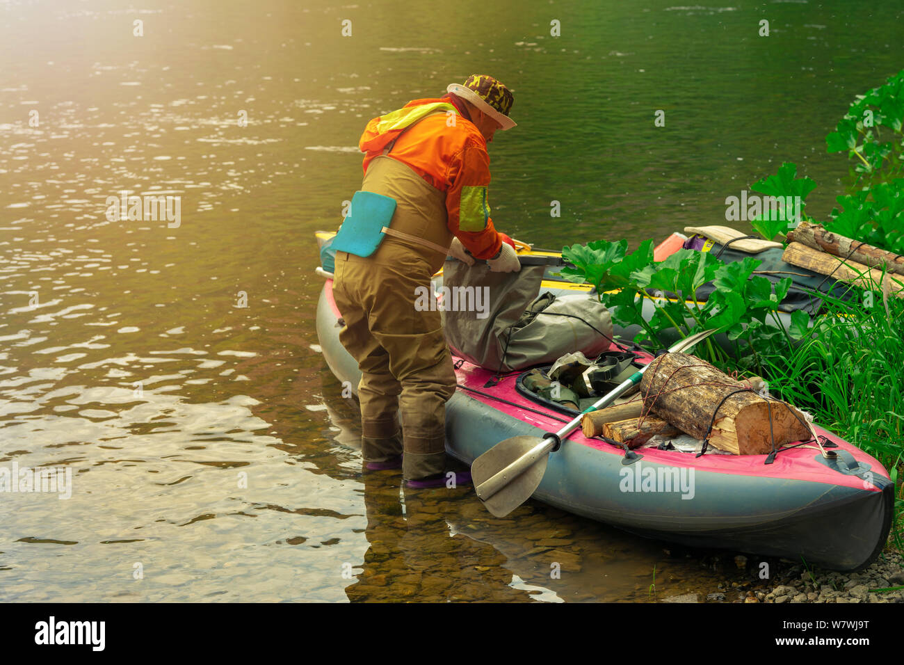 Focus some part of young person are rafting in river. Summer green river boat scene Stock Photo
