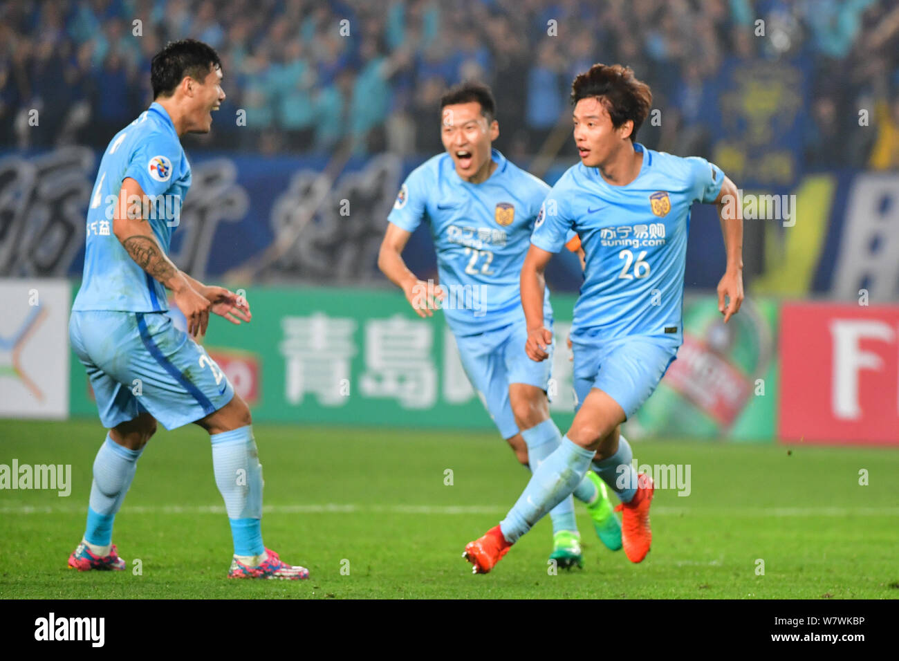 Hong Jeong-ho, right, and other players of China's Jiangsu Suning celebrate after scoring a goal against Japan's Gamba Osaka in their Group H match du Stock Photo