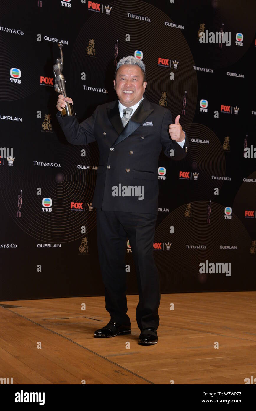 Hong Kong actor Eric Tsang poses with his trophy after winning the Best  Supporting Actor award for his movie Mad World during the 36th Hong Kong  Fil Stock Photo - Alamy