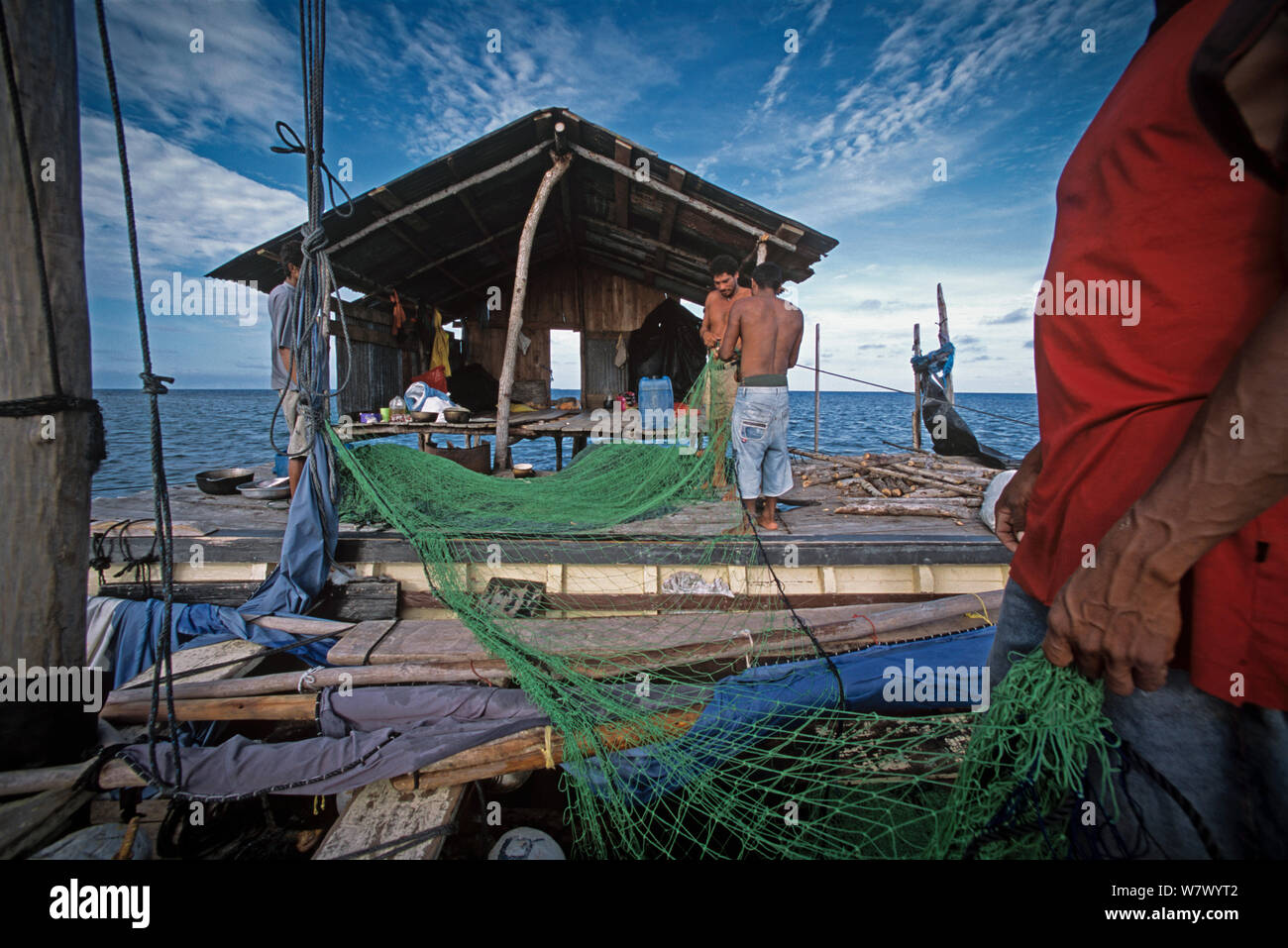 Miskito Indian fishermen preparing gill net, Puerto Cabezas, Nicaragua, Caribbean Sea. Model released. Stock Photo
