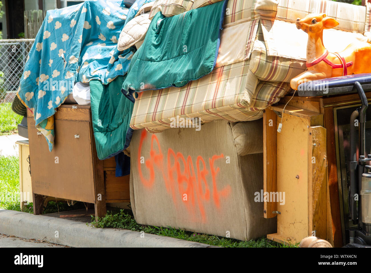 A pile of garbage waiting to be picked up is sitting on the curb Stock