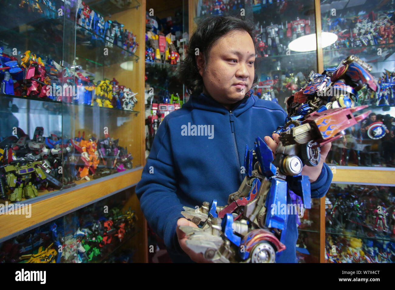 Chinese Transformers fan Wang Geng shows a model Transformer at his