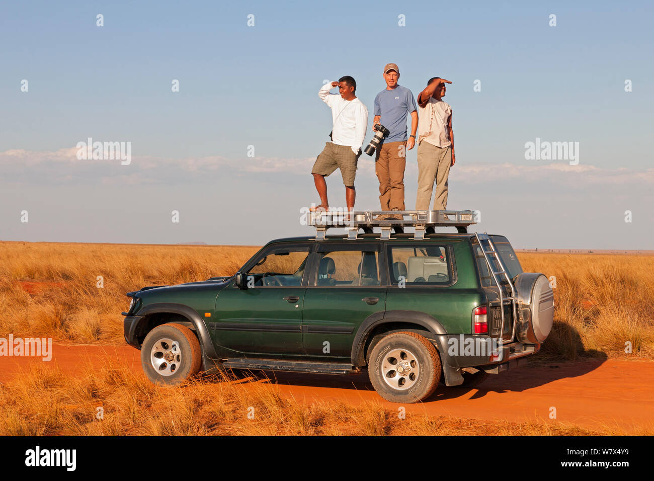 Wildlife Photographer Ingo Arndt with driver and assistant searching for migratory locust swarms near Isalo National Park, Madagascar, August 2013. Stock Photo