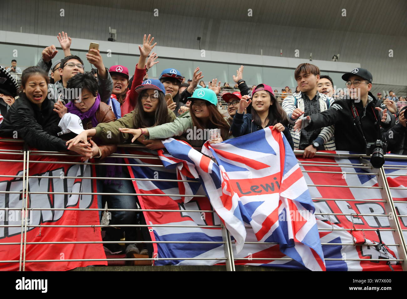 Fans of British F1 driver Lewis Hamilton of Mercedes wave British flags to show their support at the Shanghai International Circuit in Shanghai, China Stock Photo