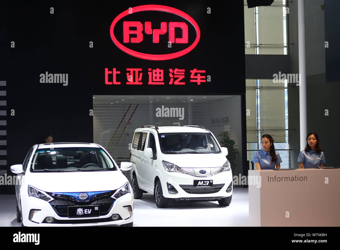 --FILE--Chinese employees are seen at the stand of BYD during an automobile exhibition in Shanghai, China, 18 November 2016.   Chinese vehicle manufac Stock Photo