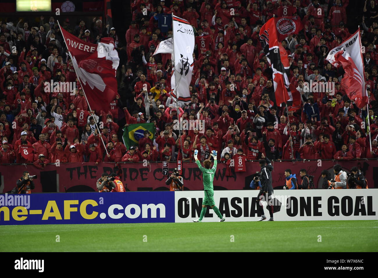 Shusaku Nishikawa of Japan's Urawa Red Diamonds waves to Japanese football fans after defeating China's Shanghai SIPG in their Group F match during th Stock Photo
